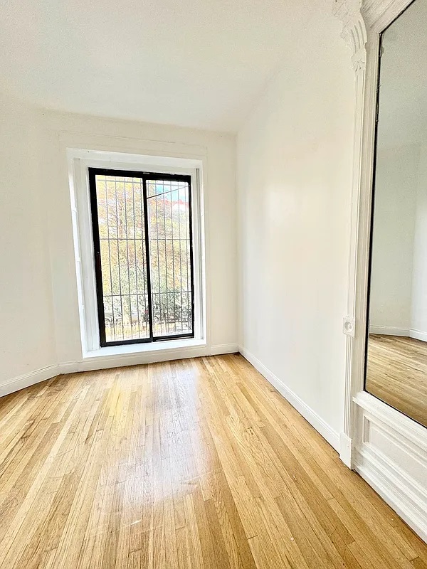 238 Gates Avenue, Unit 2 Brooklyn, NY 11238 - Photo 9 of 13 a view of an empty room with wooden floor and a window