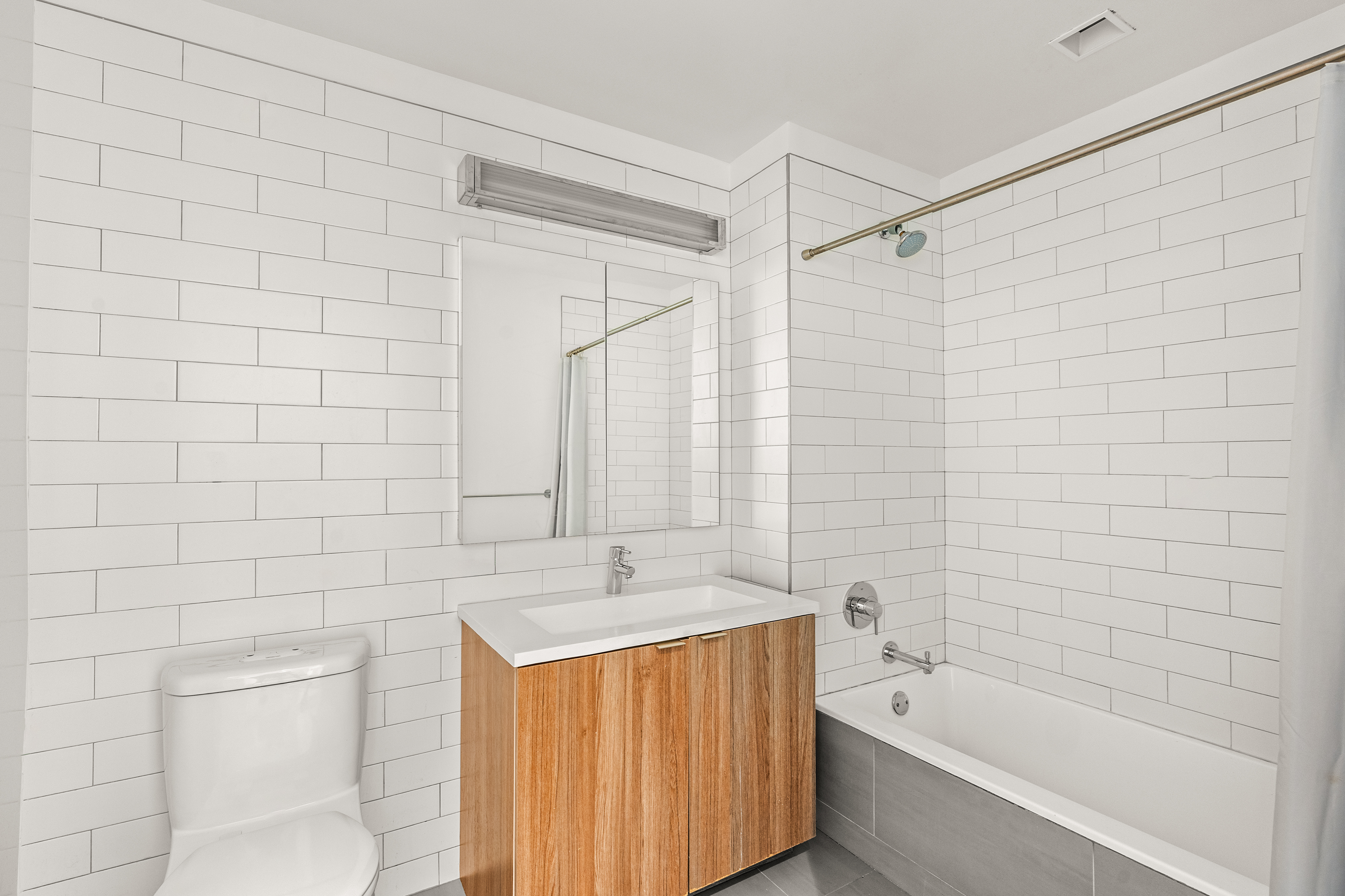 23 West 116th Street, Unit 7A Manhattan, NY 10026 - Photo 8 of 14 a bathroom with a bathtub a shower a toilet and a sink