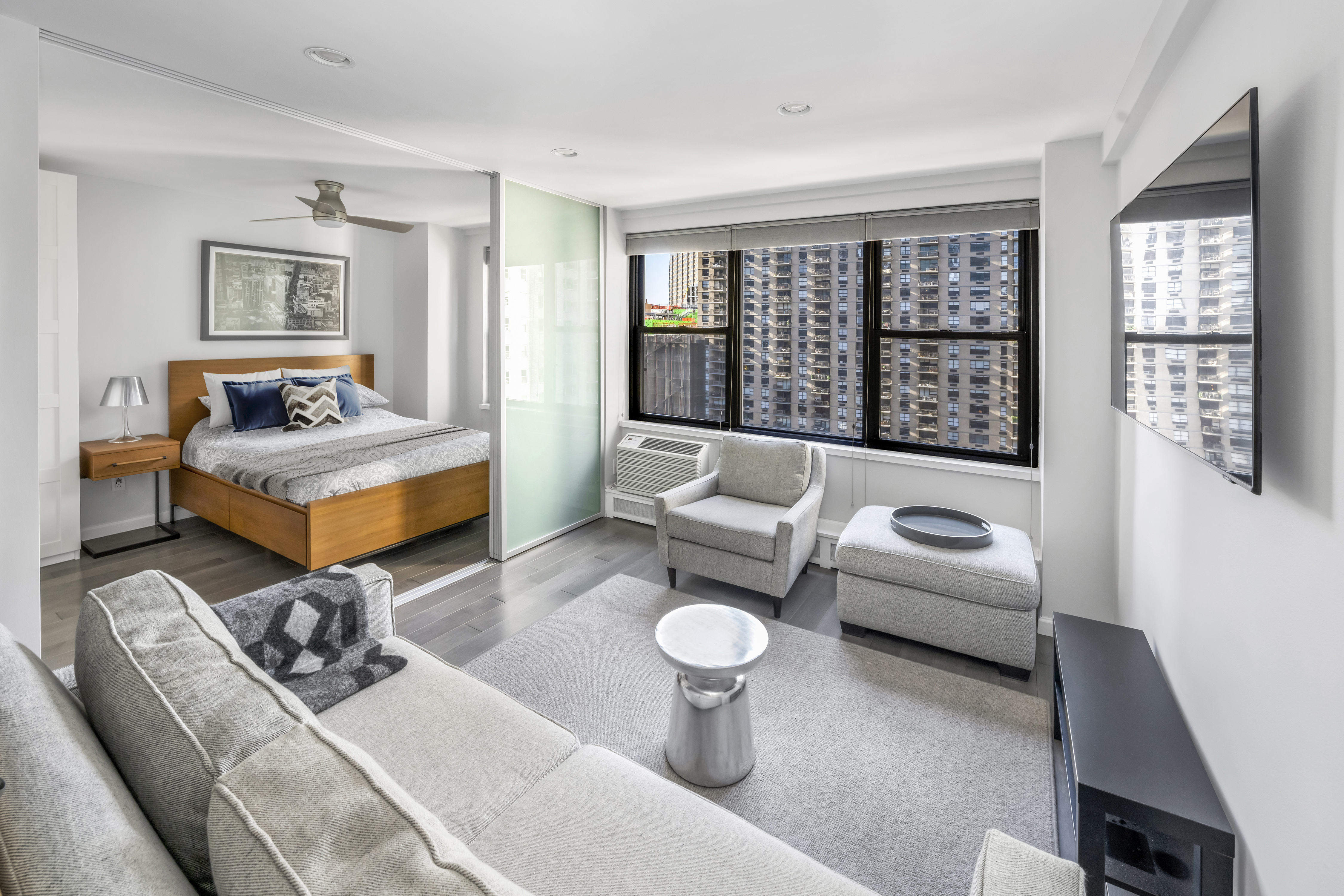 2 Tudor City Place, Unit 9OS Manhattan, NY 10017 - Photo 1 of 11 a living room with furniture and a large window