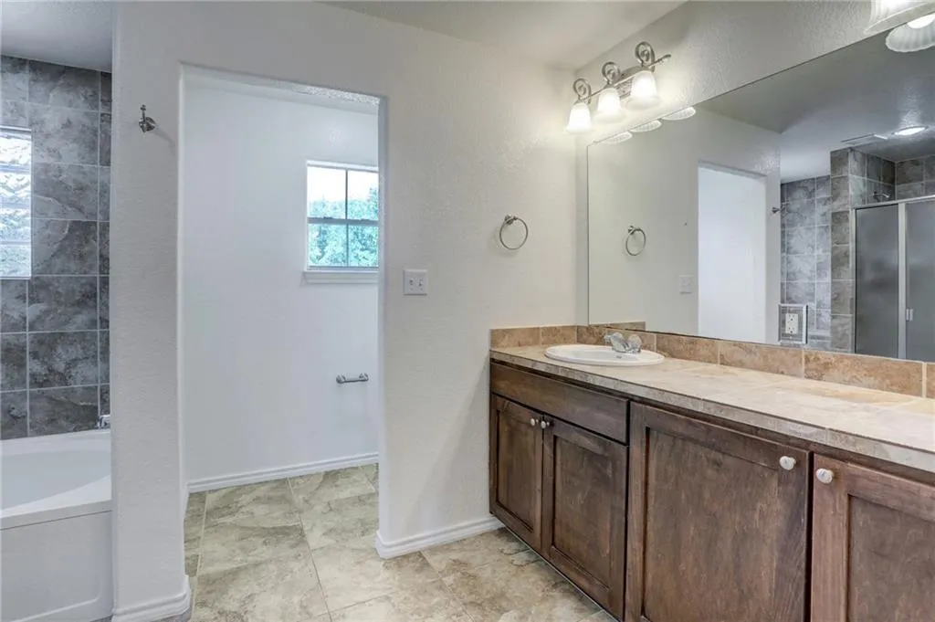 a bathroom with a sink a vanity and a mirror