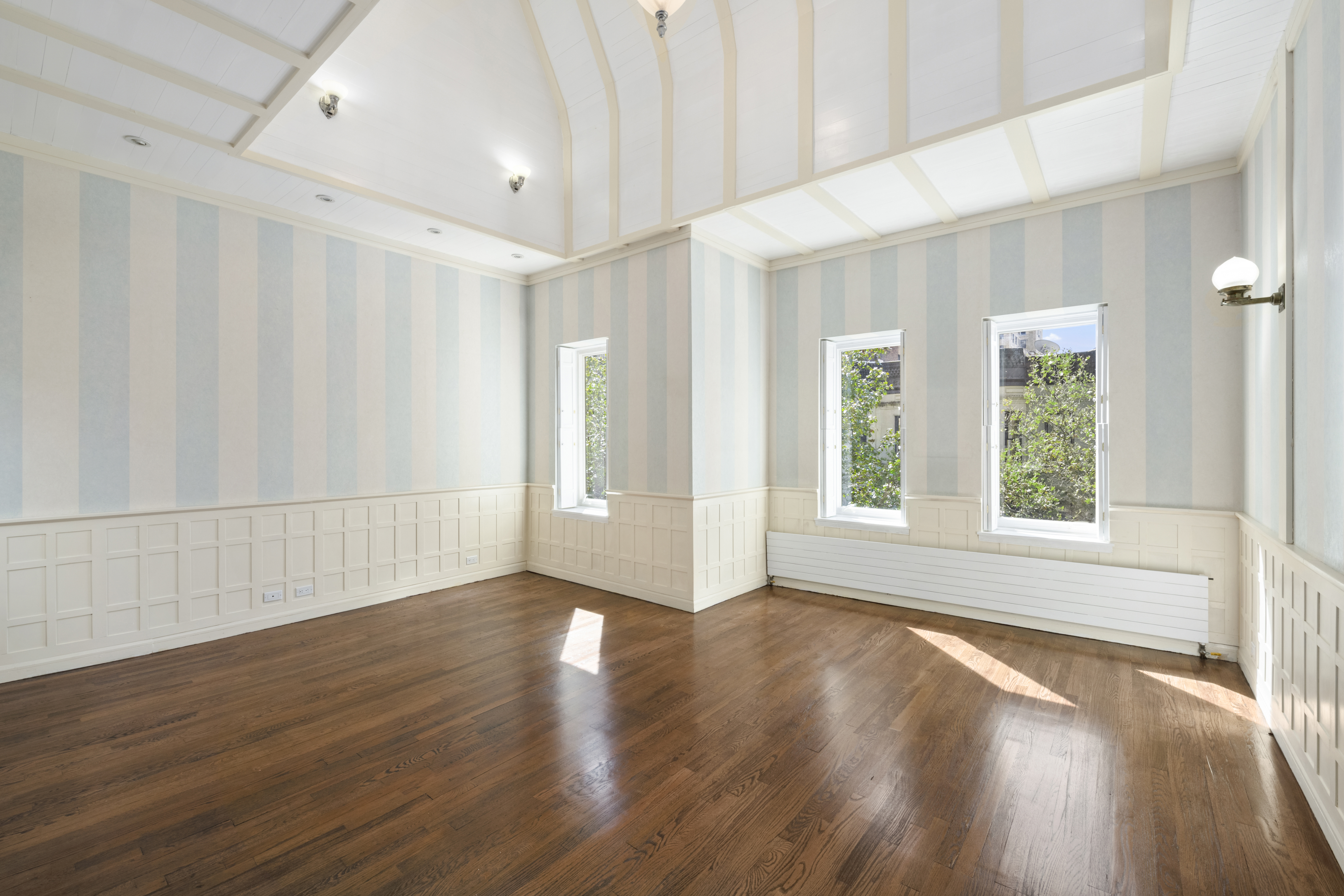 313 West 102nd Street Manhattan, NY 10025 - Photo 31 of 36 a view of an empty room with wooden floor and a window