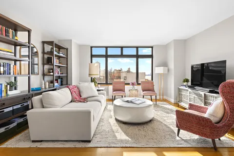 a living room with furniture large window and a flat screen tv