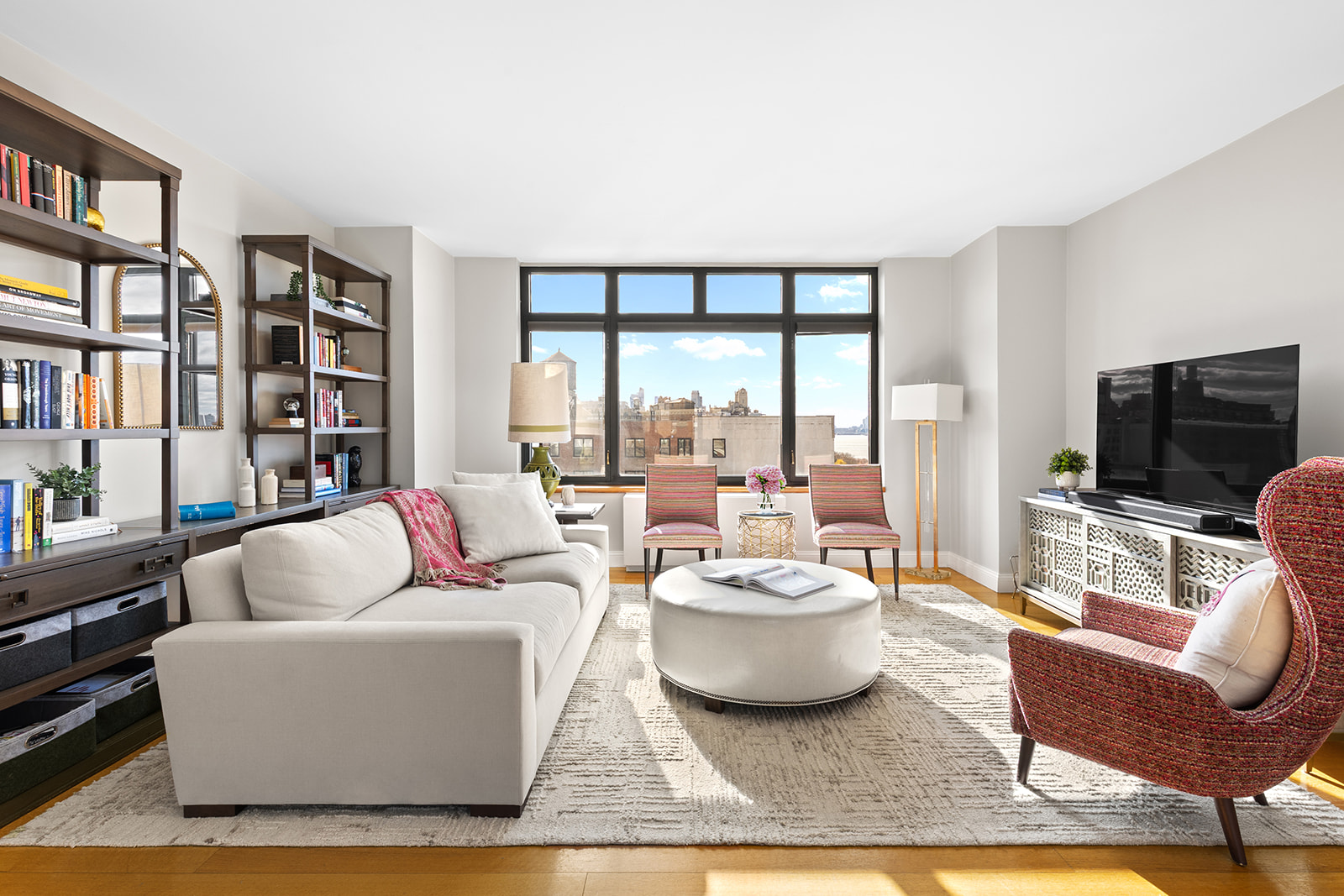 222 Riverside Drive, Unit PH2D Manhattan, NY 10025 - Photo 2 of 11 a living room with furniture large window and a flat screen tv