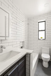 a bathroom with a sink a toilet and mirror