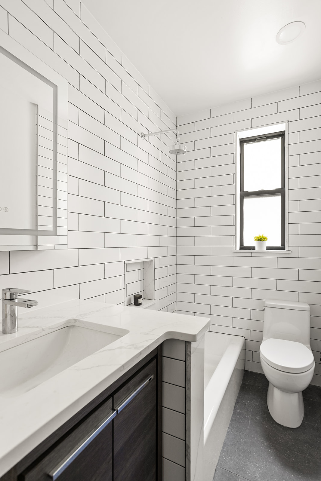 83-10 35th Avenue, Unit 3F Queens, NY 11372 - Photo 7 of 13 a bathroom with a sink a toilet and mirror