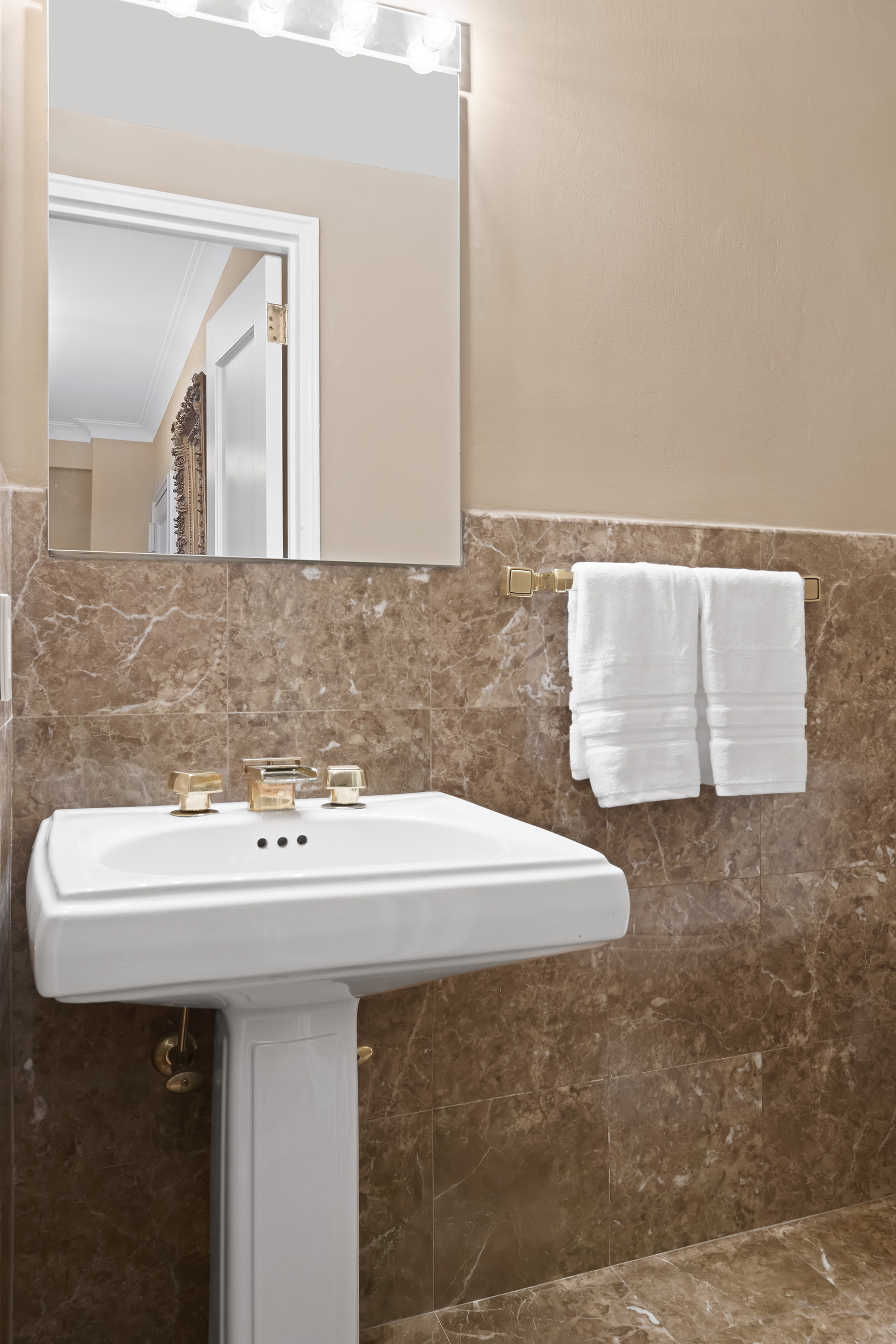 710 Park Avenue, Unit 5F Manhattan, NY 10021 - Photo 9 of 11 a bathroom with a sink and a mirror