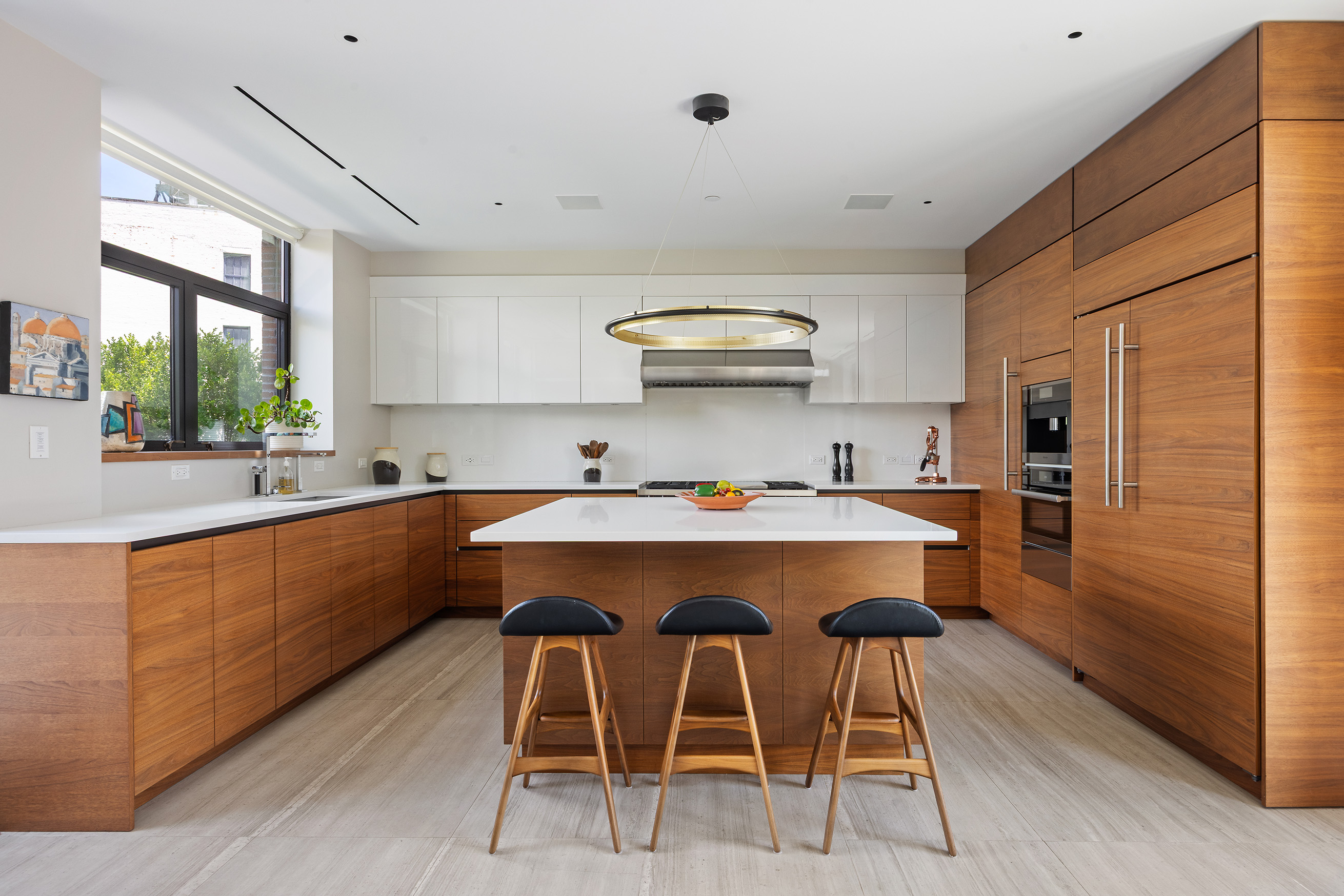 15 Leonard Street, Unit PH Manhattan, NY 10013 - Photo 12 of 37 a kitchen with stainless steel appliances a sink a stove a refrigerator cabinets and a dining table
