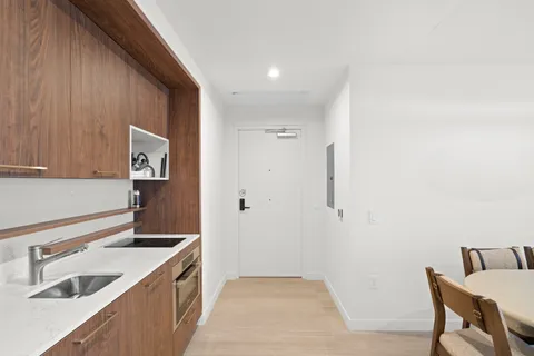 a kitchen with a sink cabinets and appliances