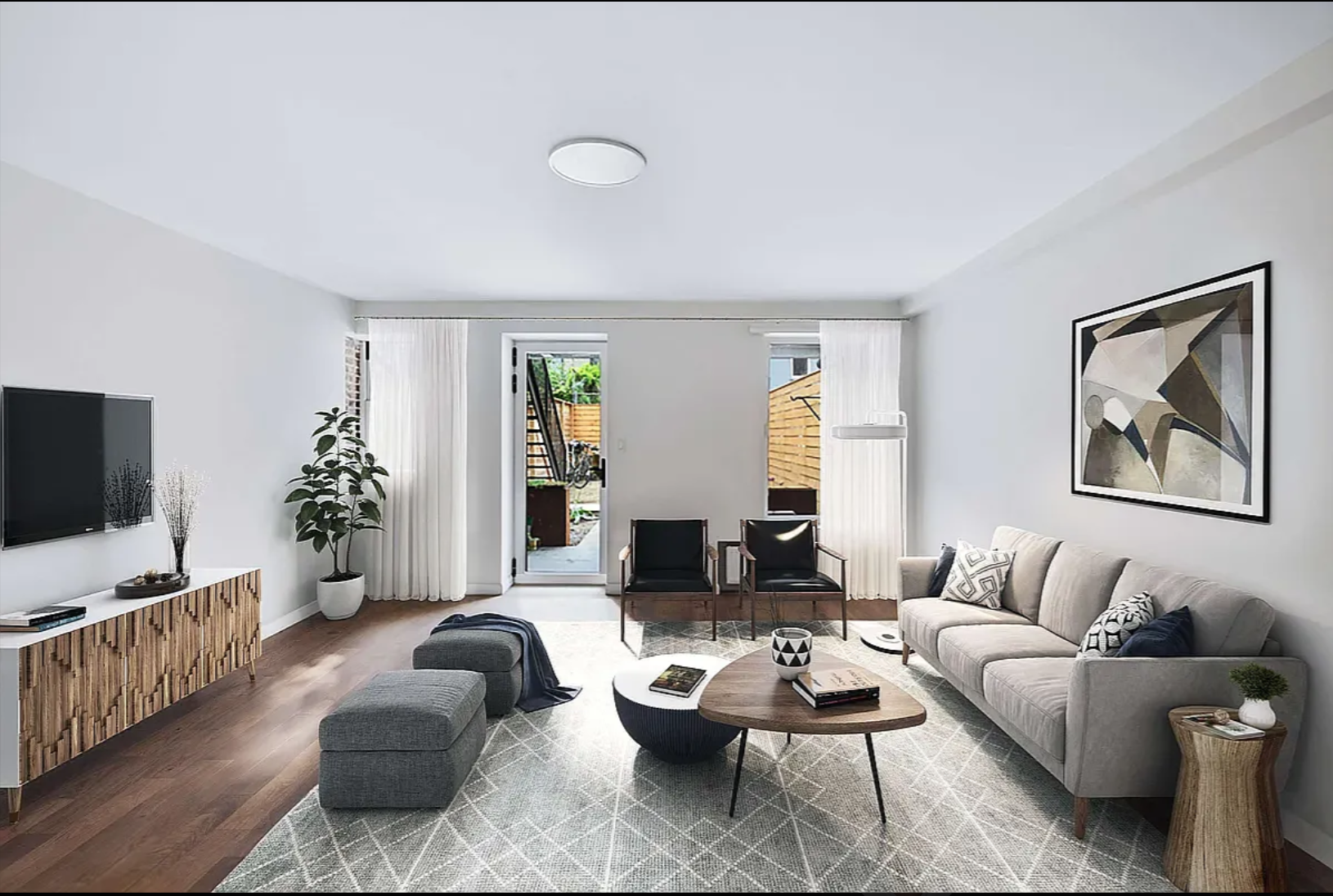 430 East 140th Street, Unit 2 Bronx, NY 10454 - Photo 1 of 10 a living room with furniture and a flat screen tv