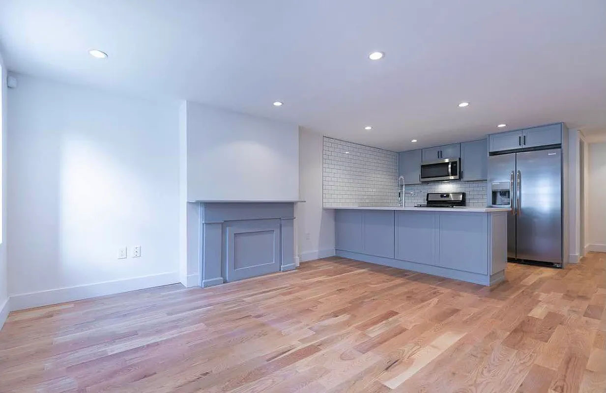 a kitchen with stainless steel appliances granite countertop a refrigerator and a sink