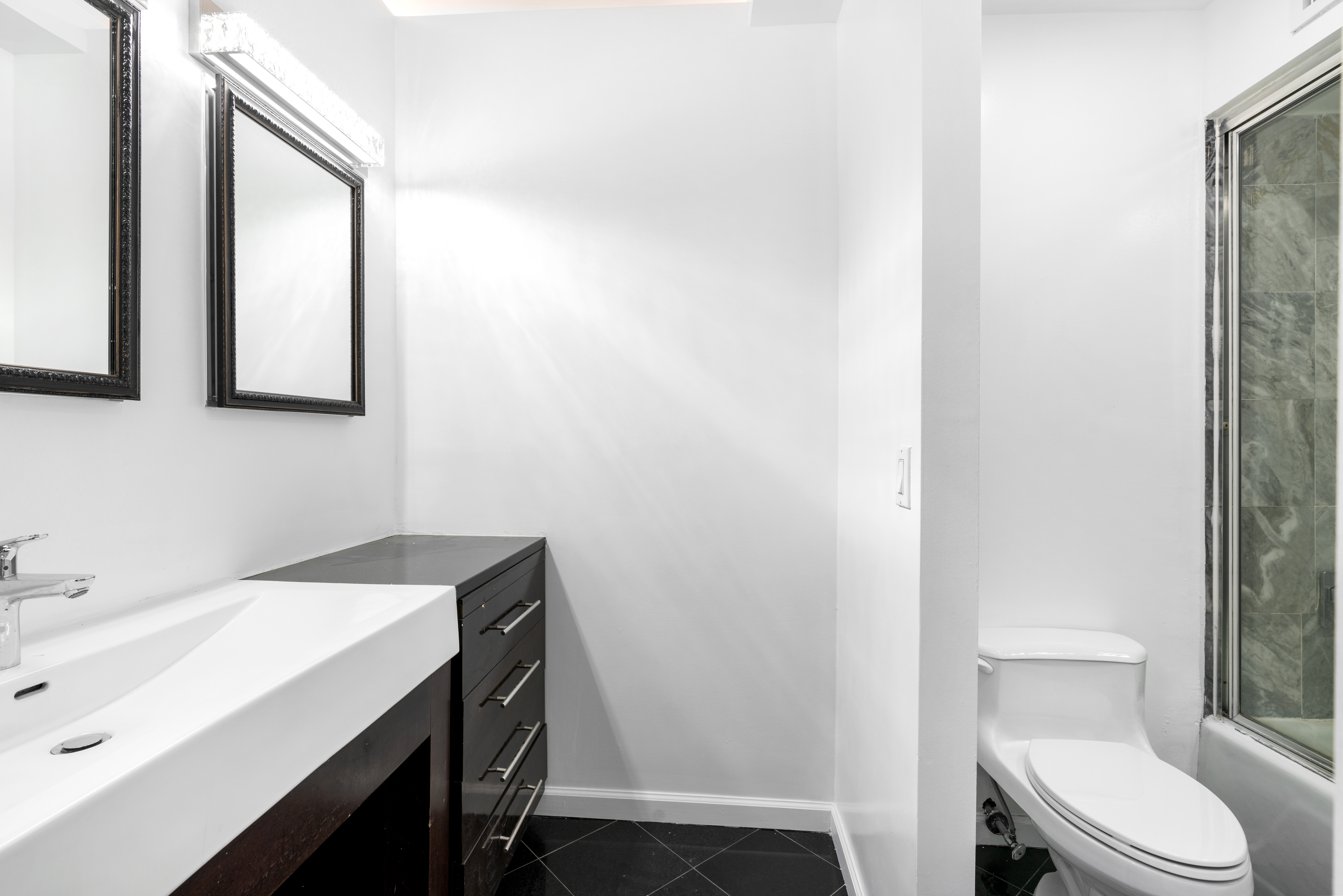 152 East 74th Street, Unit 2 Manhattan, NY 10021 - Photo 15 of 16 a bathroom with a sink a toilet and vanity