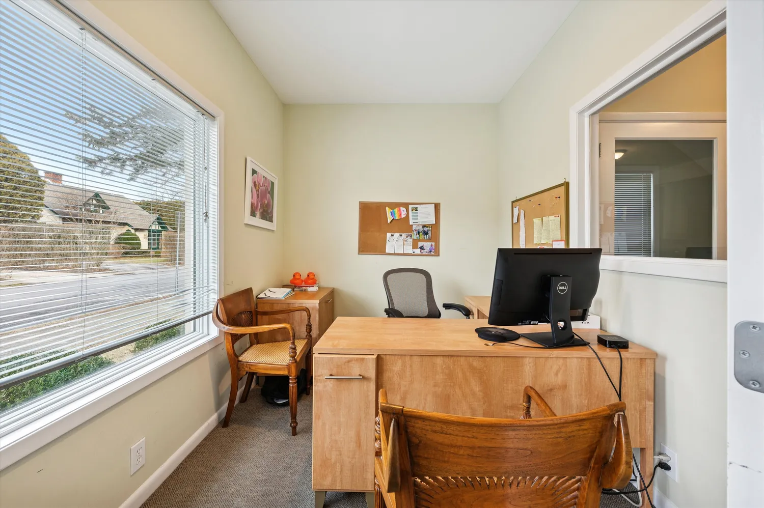 a view of a livingroom with workspace and a window