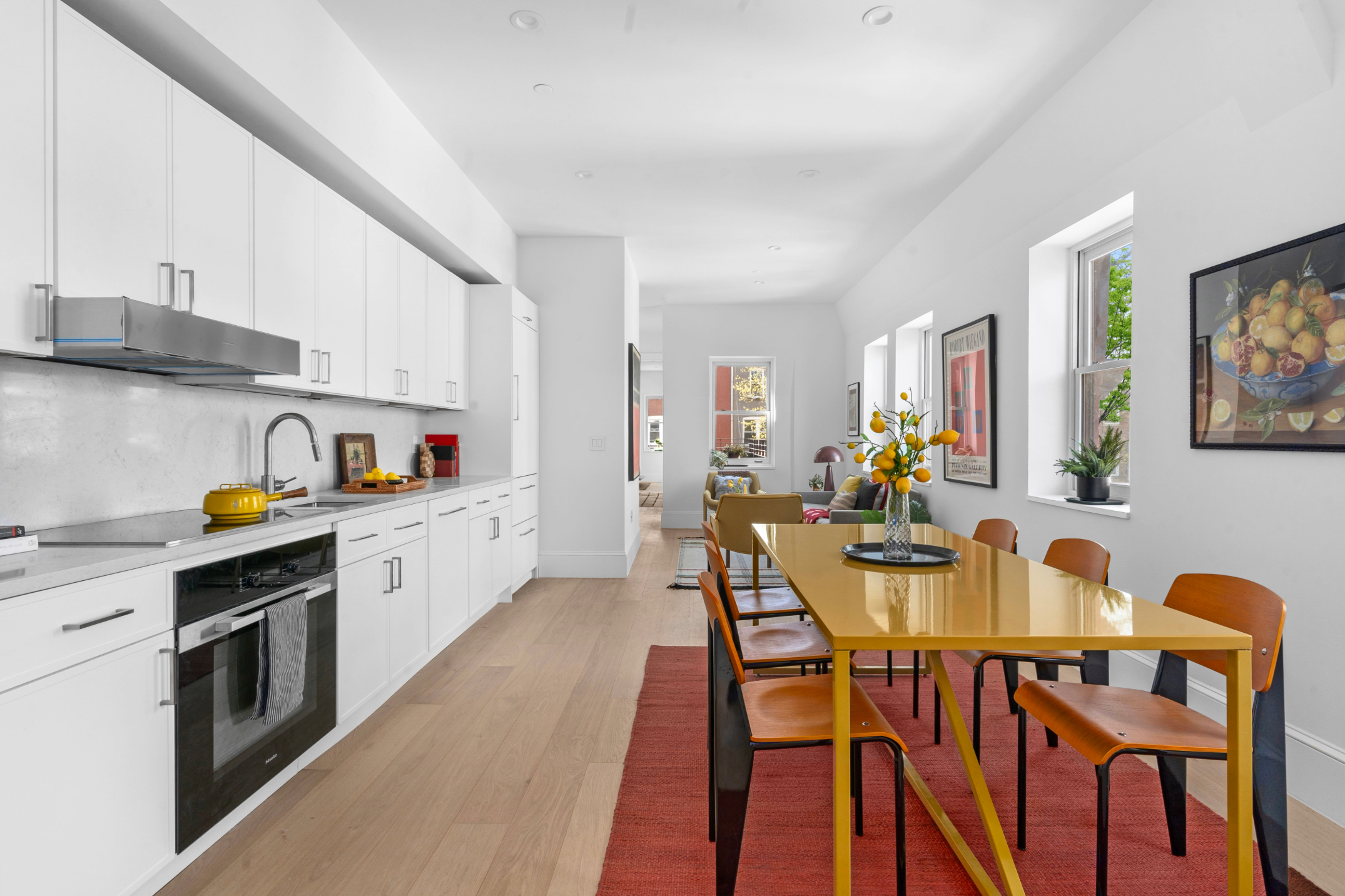 1370 Dean Street, Unit PHD Brooklyn, NY 11216 - Photo 3 of 12 a kitchen with stainless steel appliances a white table and chairs in it