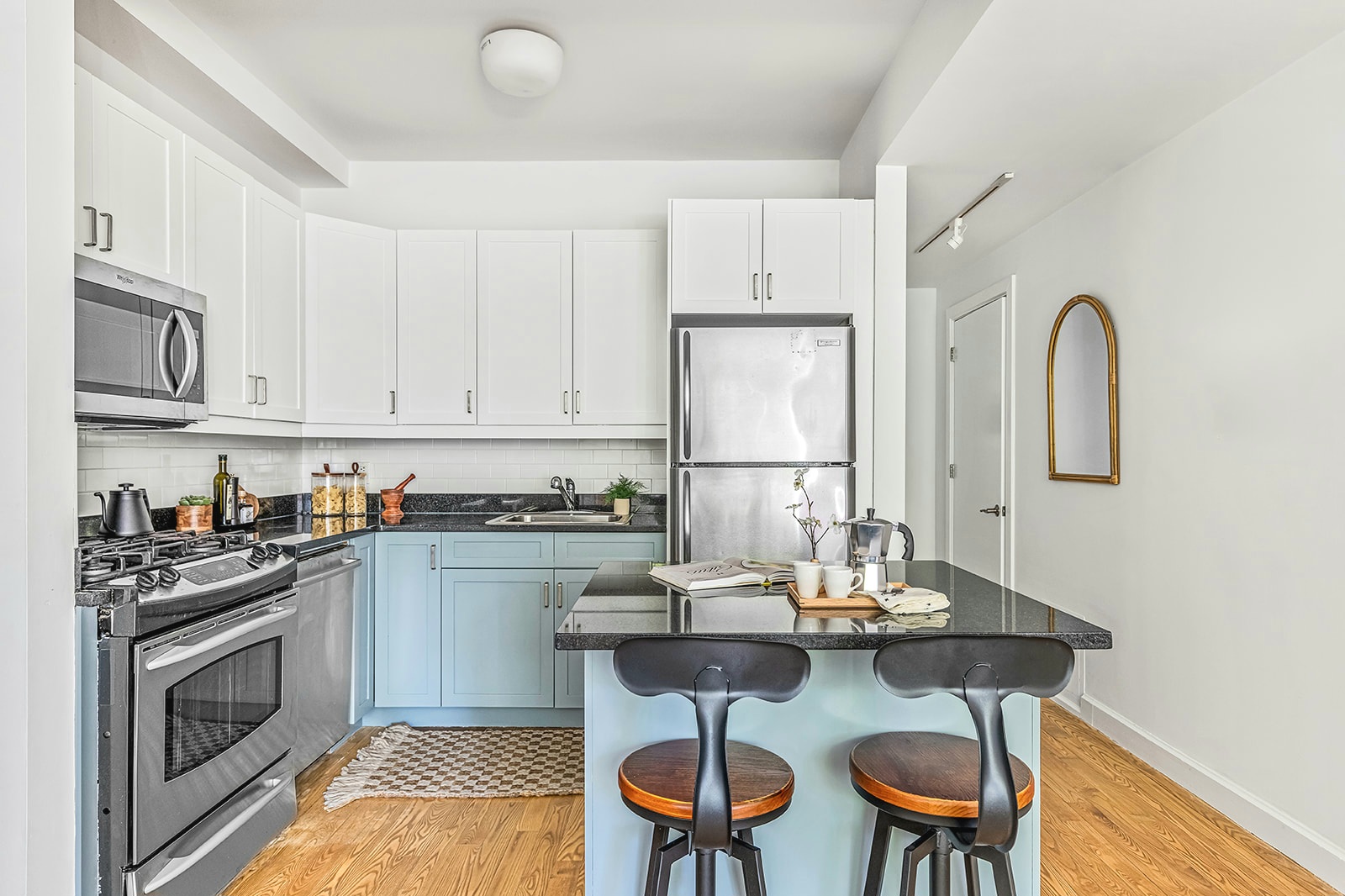 372 15th Street, Unit 2A Brooklyn, NY 11215 - Photo 4 of 10 a kitchen with stainless steel appliances granite countertop a stove a sink dishwasher and white cabinets with wooden floor