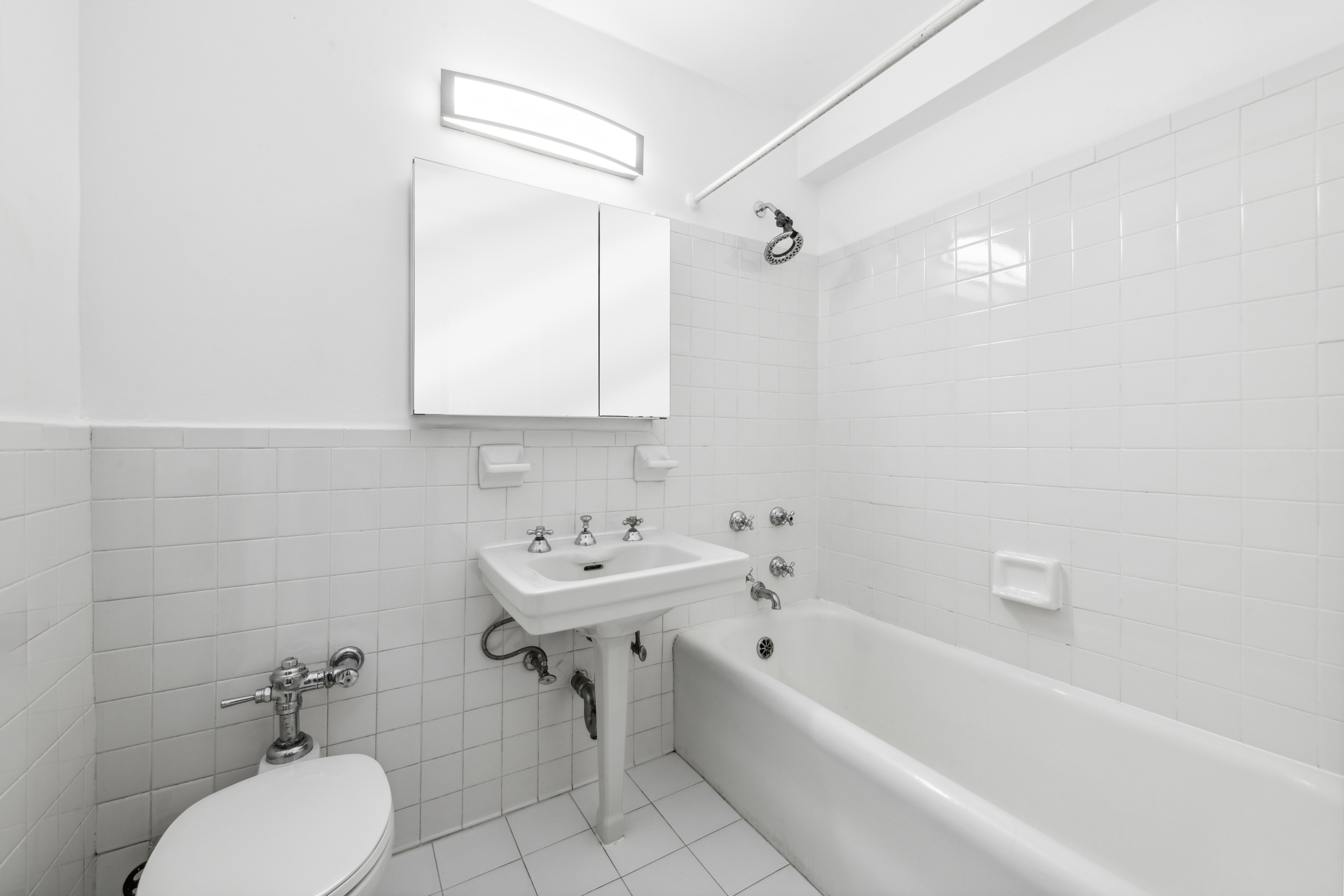 433 West 34th Street, Unit 8D Manhattan, NY 10001 - Photo 7 of 15 a bathroom with a sink toilet and bathtub