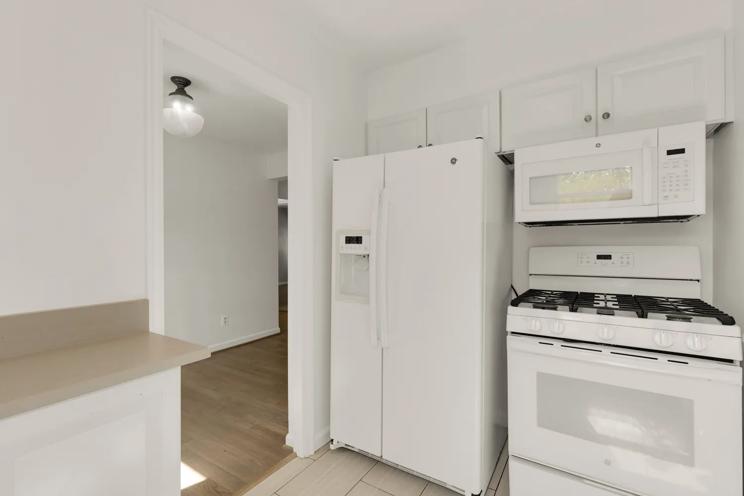 a white refrigerator freezer and a stove sitting inside of a kitchen