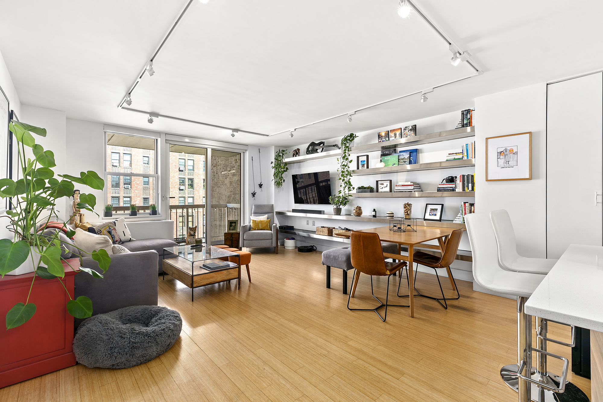 420 West 23rd Street, Unit 6B Manhattan, NY 10011 - Photo 2 of 11 a living room with fireplace furniture and a flat screen tv