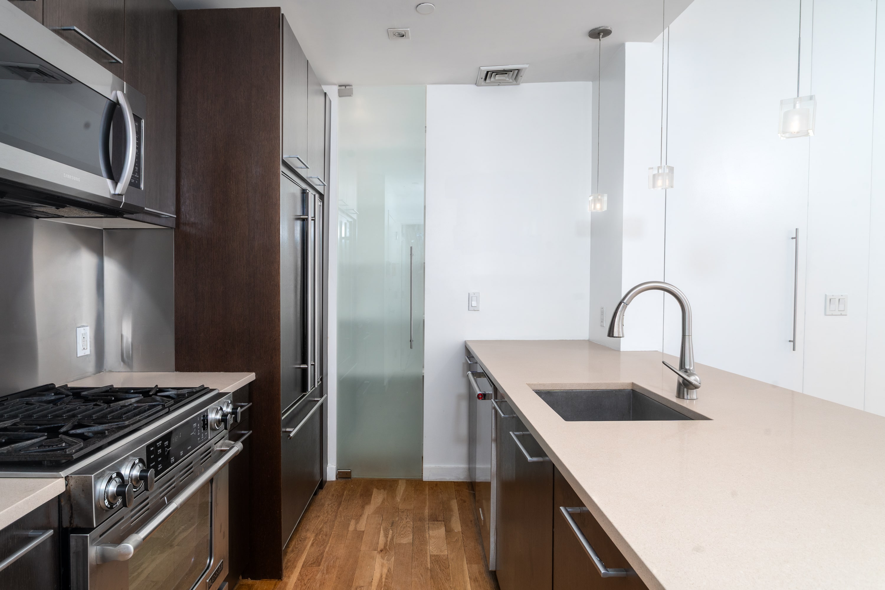 342 East 110th Street, Unit 3D Manhattan, NY 10029 - Photo 3 of 15 a kitchen with stainless steel appliances granite countertop a sink stove and refrigerator