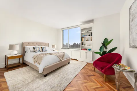 a bedroom with a large bed and a couch