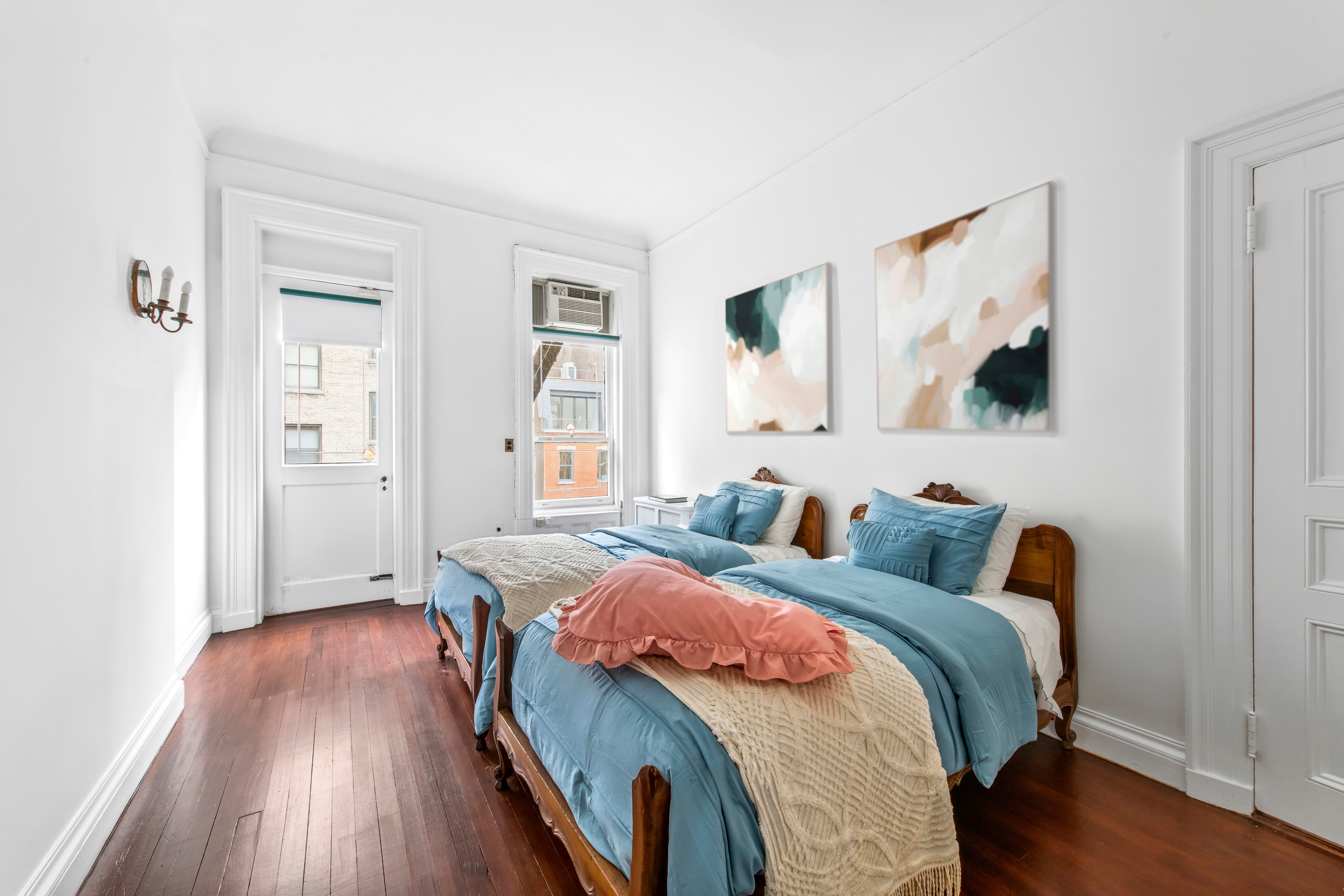 155 East 70th Street Manhattan, NY 10021 - Photo 14 of 27 a bedroom with bed and a window