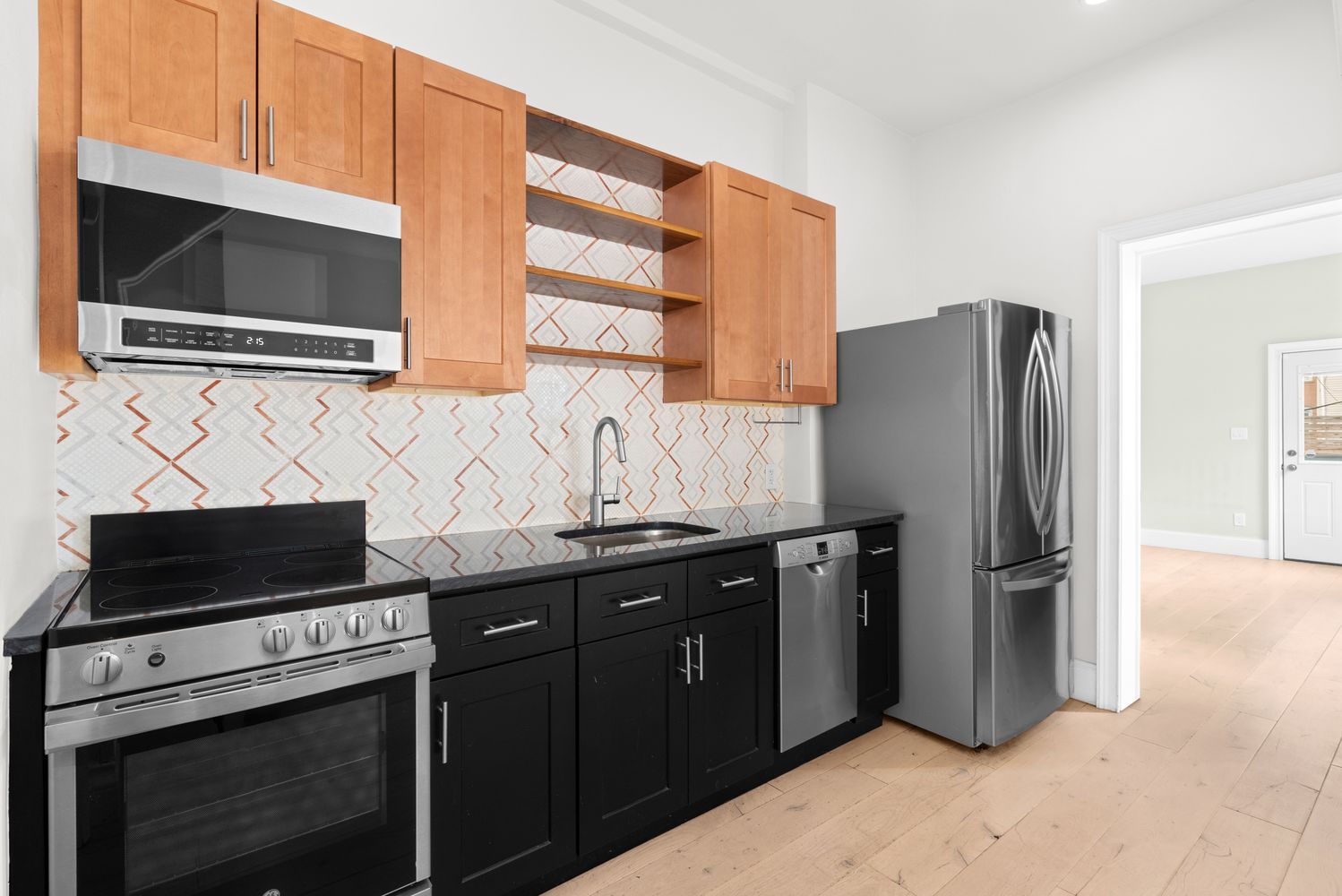 239 Withers Street Brooklyn, NY 11211 - Photo 2 of 14 a kitchen with stainless steel appliances granite countertop a refrigerator and a stove