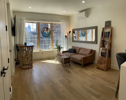 a living room with furniture and a window