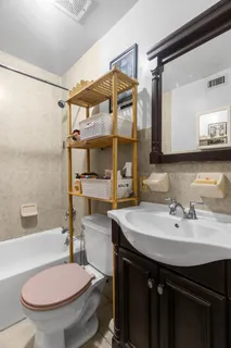a bathroom with a sink toilet and shower
