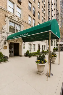 a front view of a building with a garden