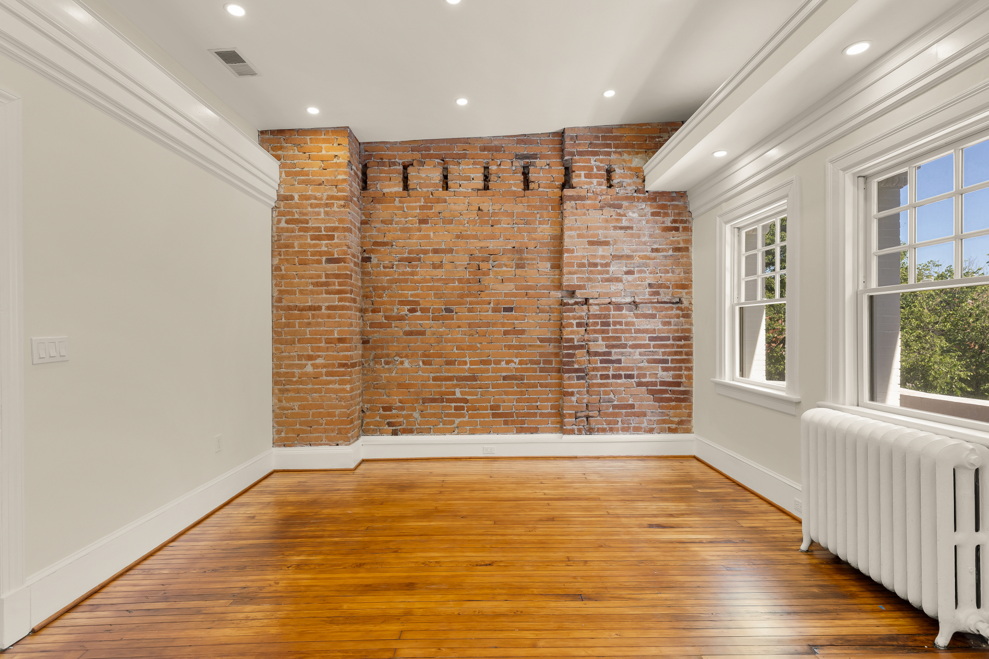 1737 Park Road Northwest Washington, DC 20010 - Photo 16 of 32 a view of an empty room with wooden floor and a window