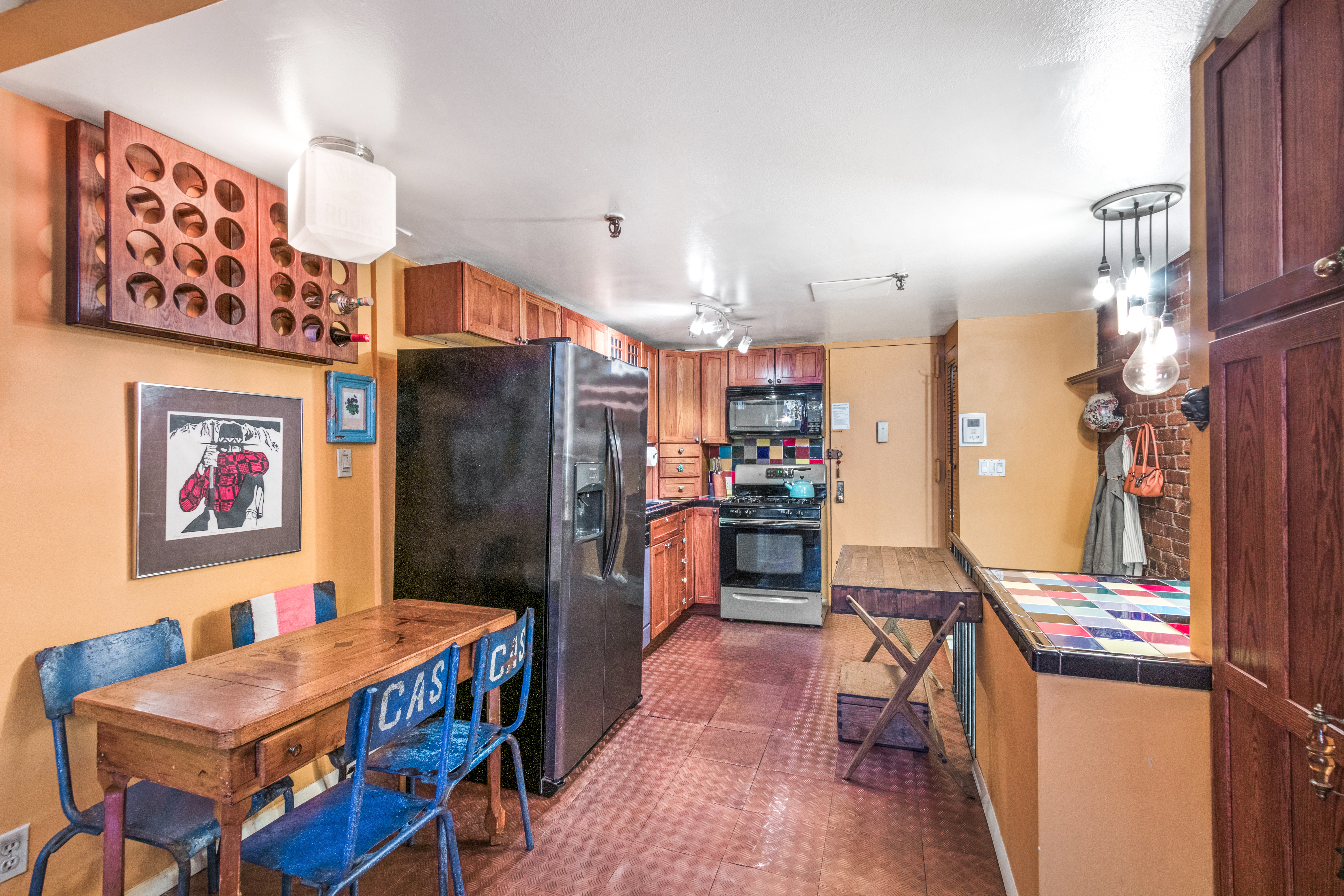 324 Pearl Street, Unit 1F Manhattan, NY 10038 - Photo 4 of 12 a kitchen that has a lot of cabinets and refrigerator