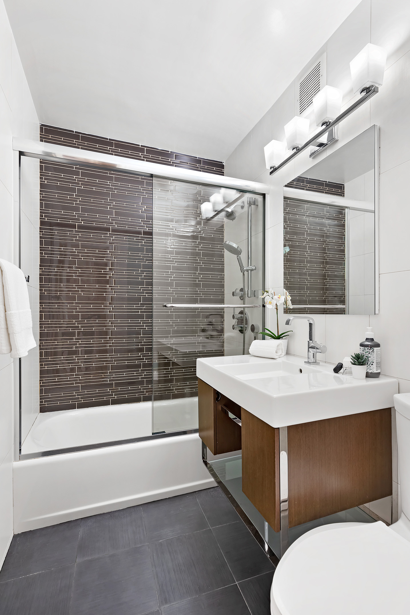 155 East 38th Street, Unit 12K Manhattan, NY 10016 - Photo 11 of 15 a bathroom with a sink and a mirror