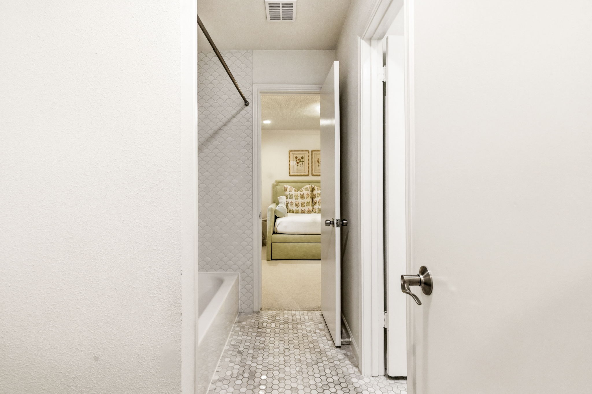 5765 Stonegate Road Dallas, TX 75209 - Photo 26 of 37 a view of a hallway with white walls and stairs