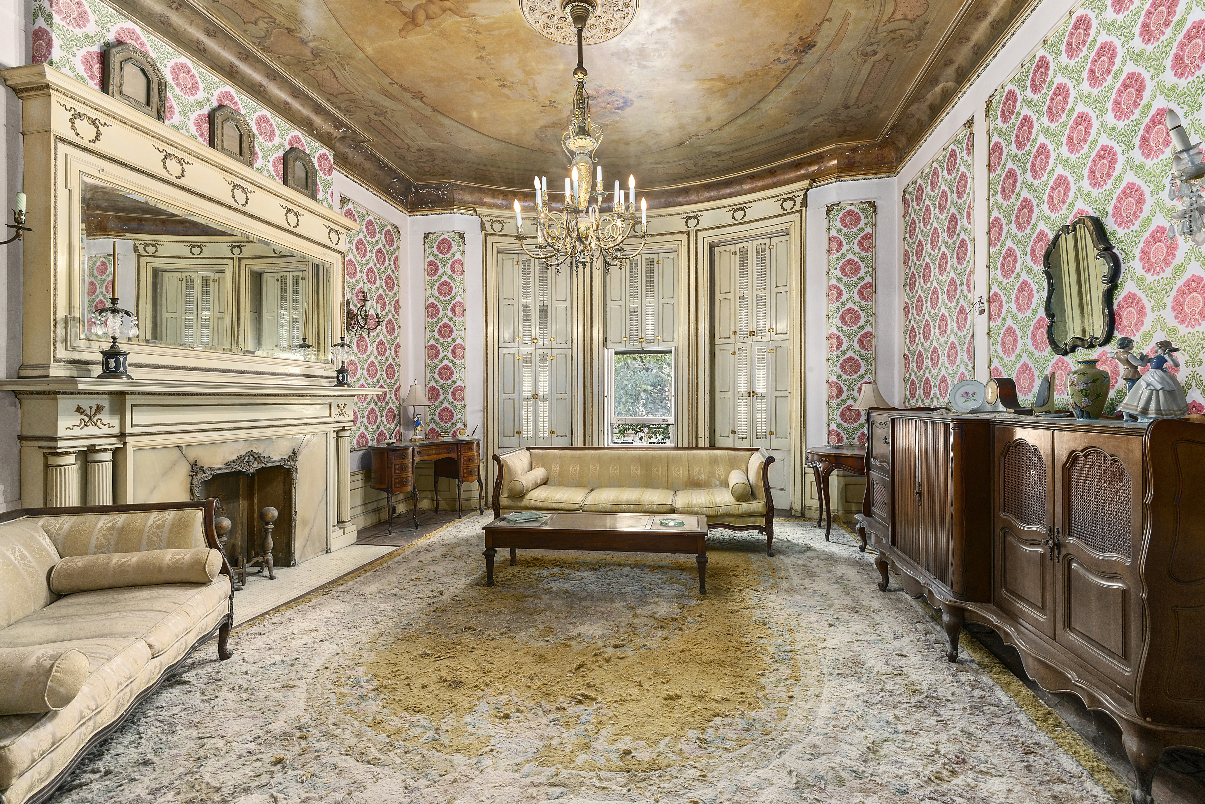 a spacious bedroom with a bed and a chandelier