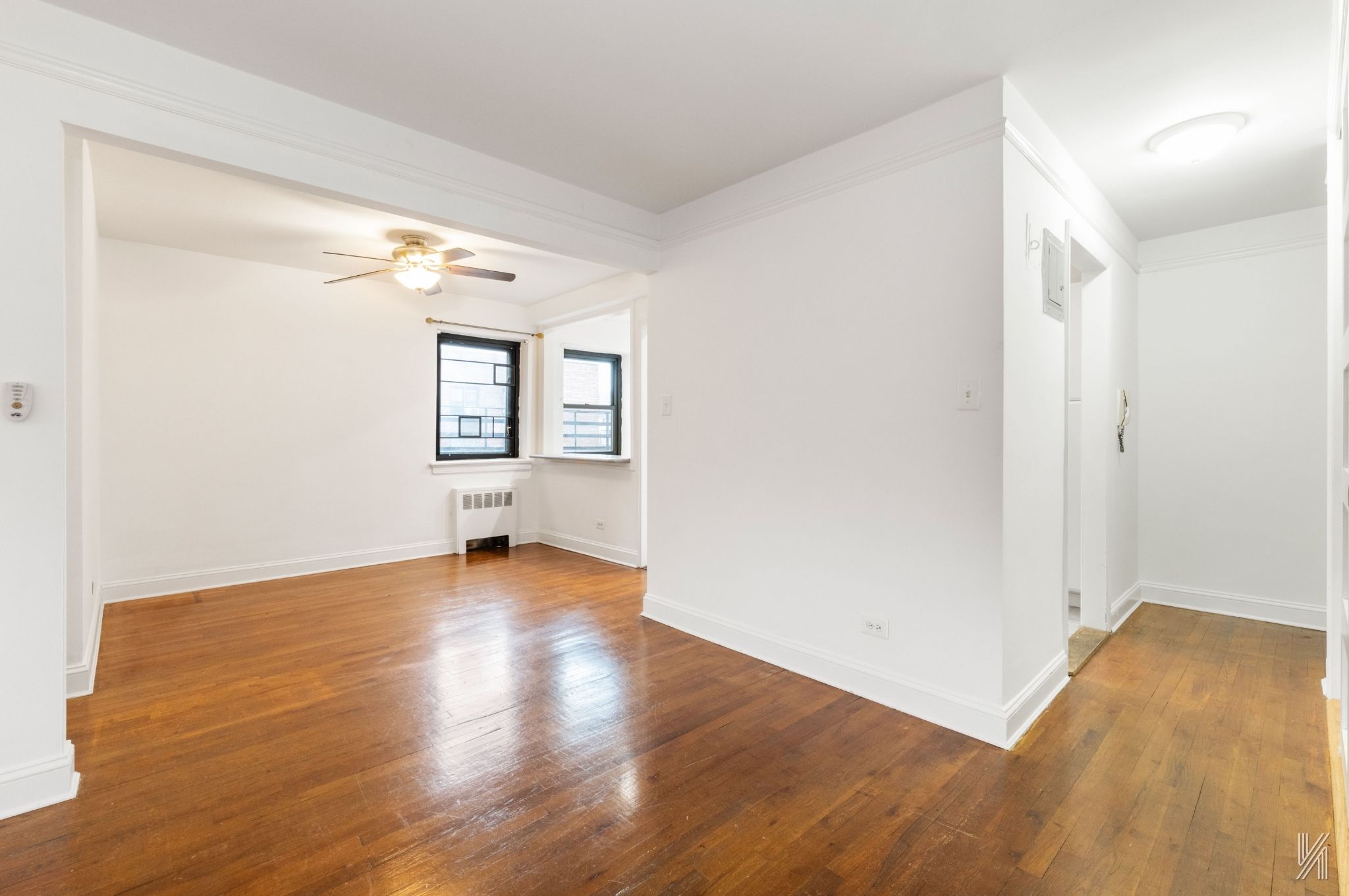 34-10 94th Street, Unit 6G Queens, NY 11372 - Photo 13 of 19 an empty room with wooden floor and windows