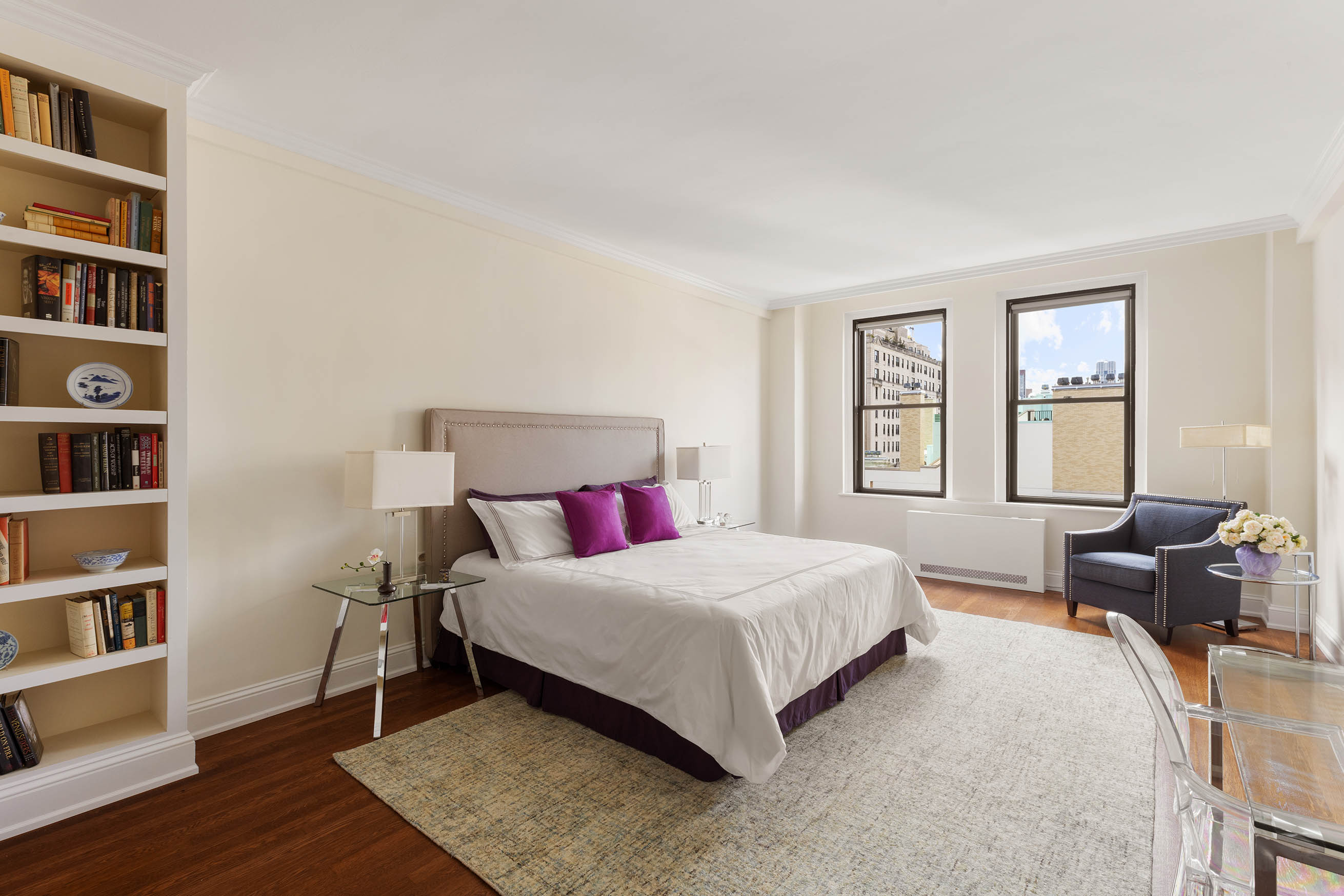 33 East 70th Street, Unit 9C Manhattan, NY 10021 - Photo 6 of 12 a bedroom with a bed furniture and a book shelf