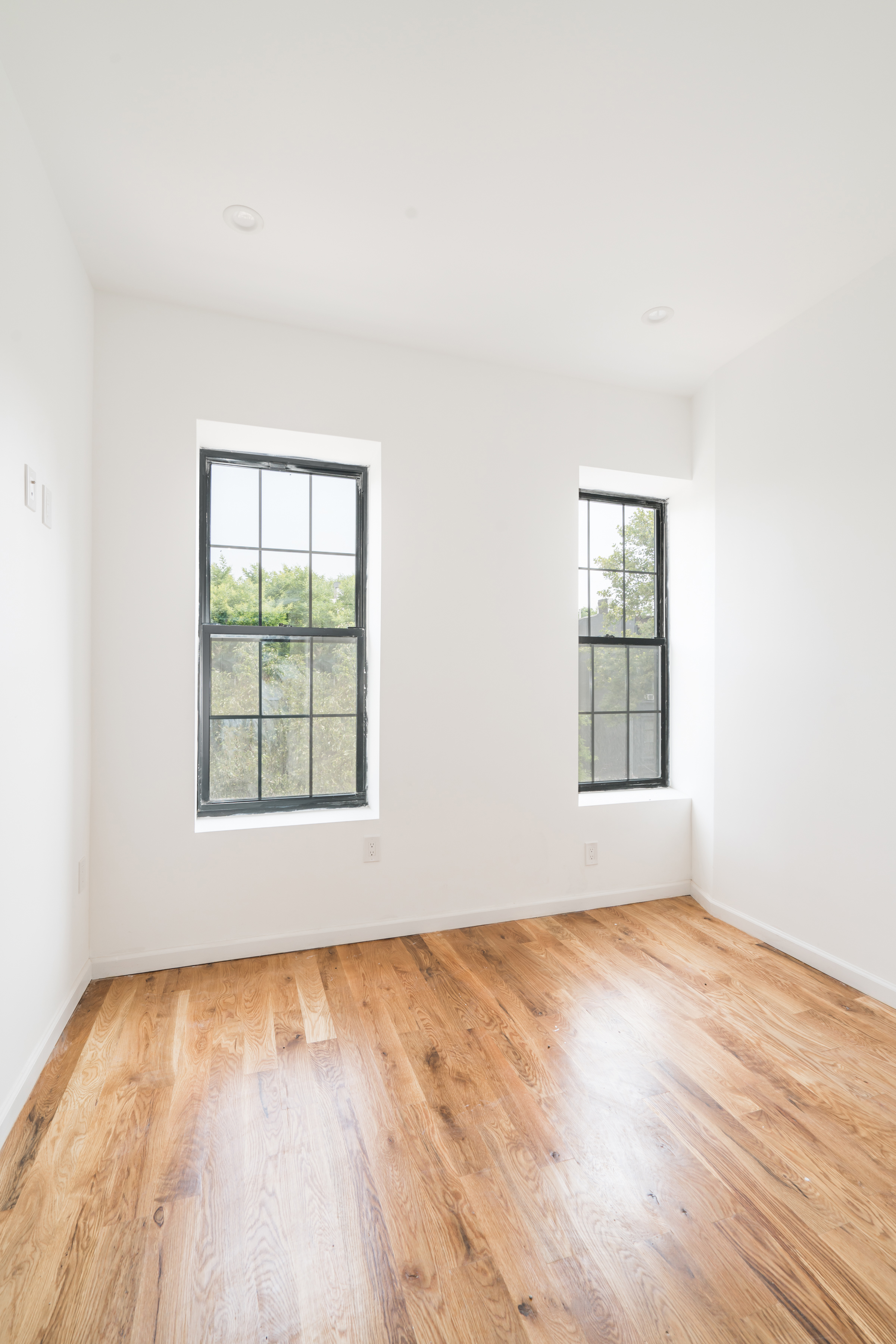 885 Lafayette Avenue, Unit 3 Brooklyn, NY 11221 - Photo 3 of 8 an empty room with wooden floor and windows