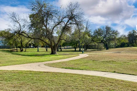 a view of a swimming pool and trees in the background