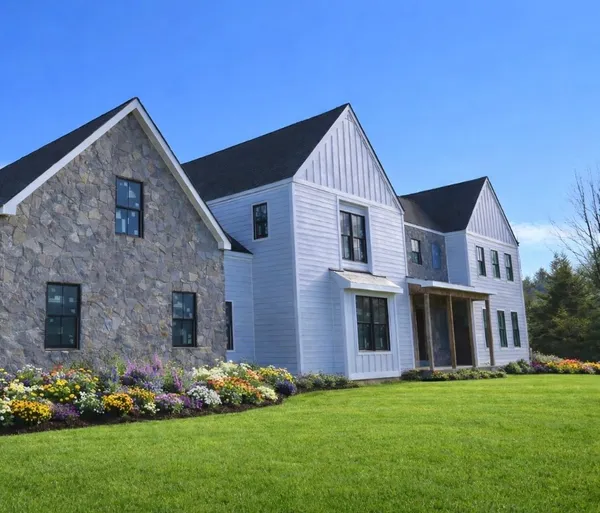 a front view of a house with a garden