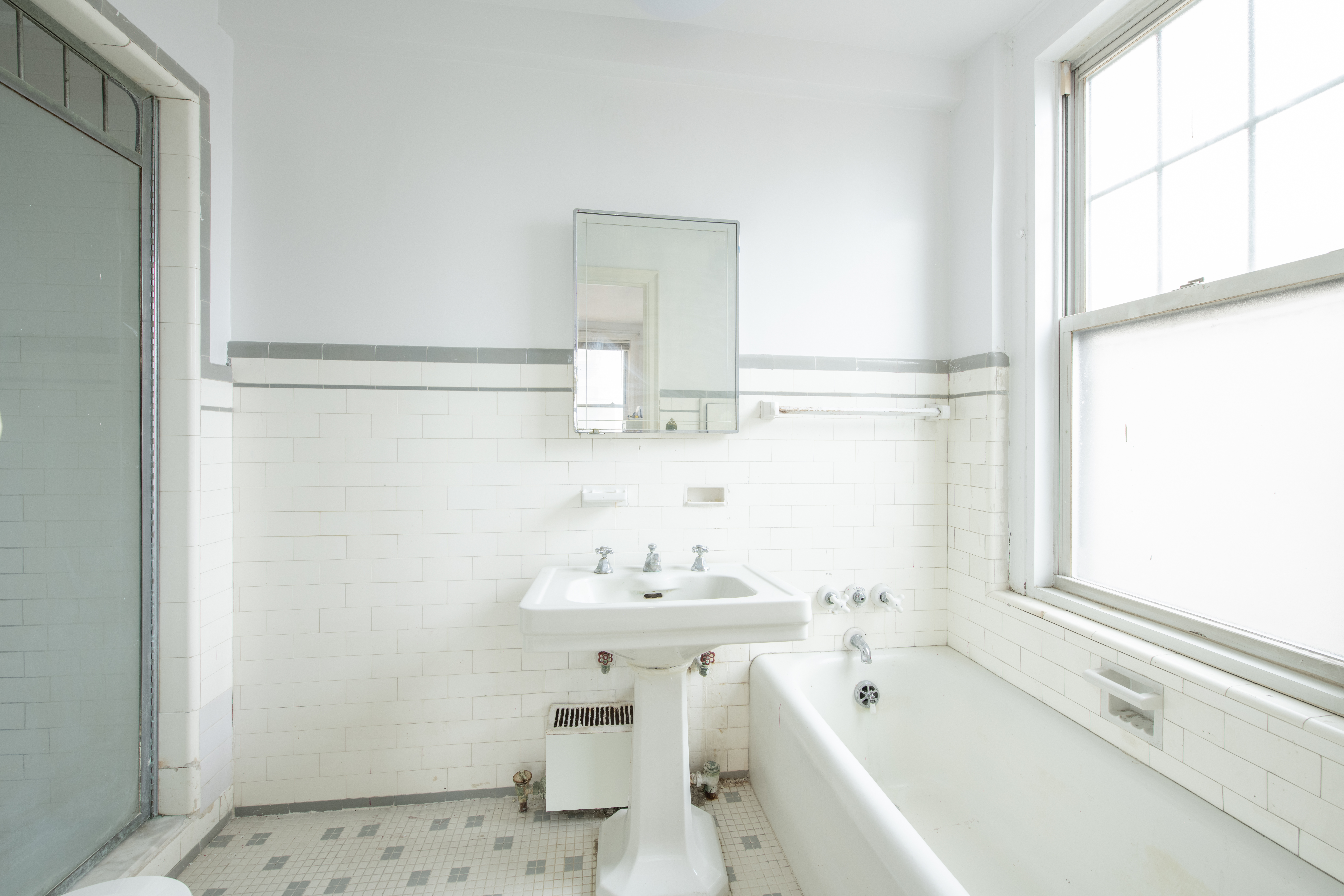 12 West 96th Street, Unit 9A Manhattan, NY 10025 - Photo 6 of 9 a bathroom with a sink a bathtub and a mirror