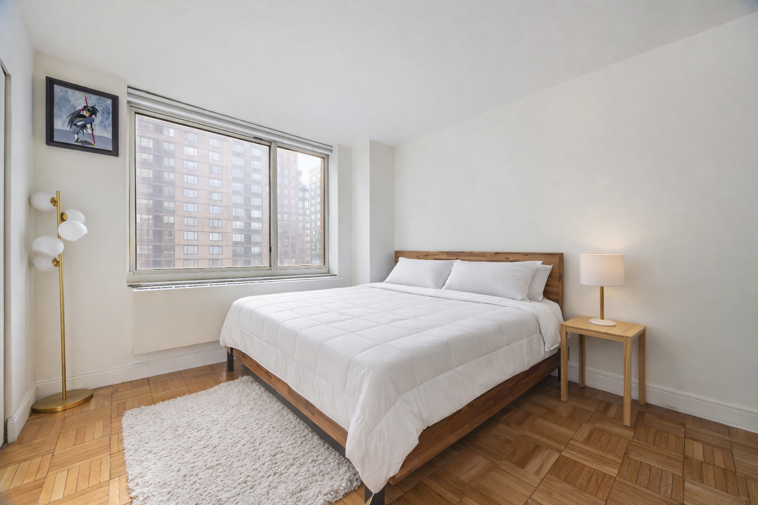 215-217 East 96th Street, Unit 26F Manhattan, NY 10128 - Photo 4 of 19 a bedroom with a bed and a window