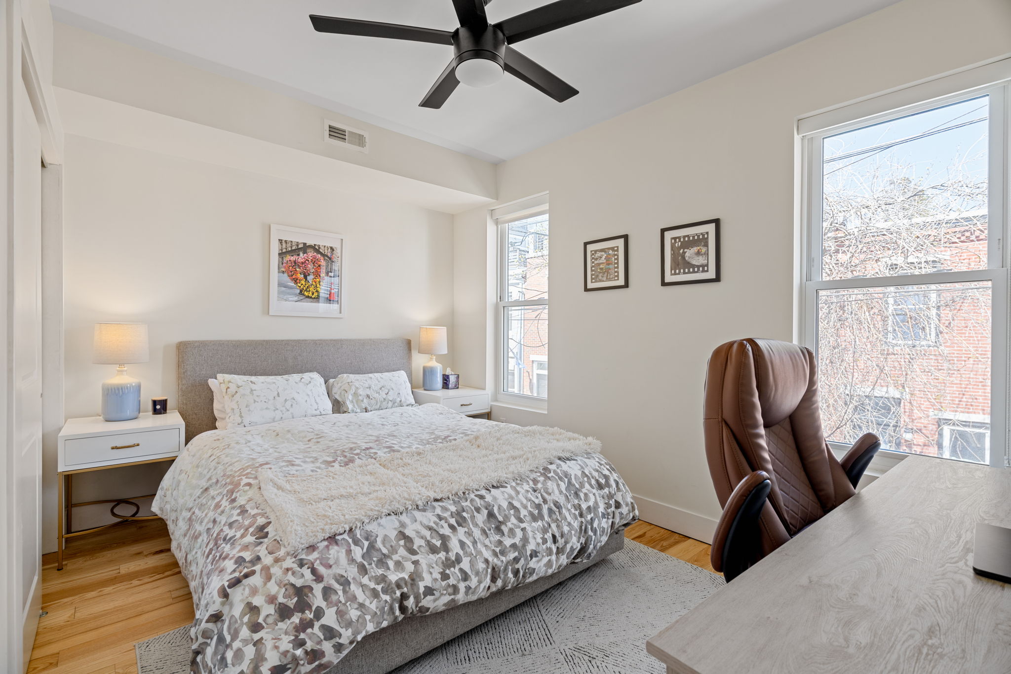 1934 Pemberton Street Philadelphia, PA 19146 - Photo 29 of 50 a bedroom with a bed a dresser and a large window