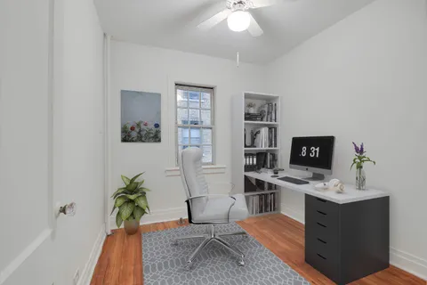 a workspace with furniture and a potted plant