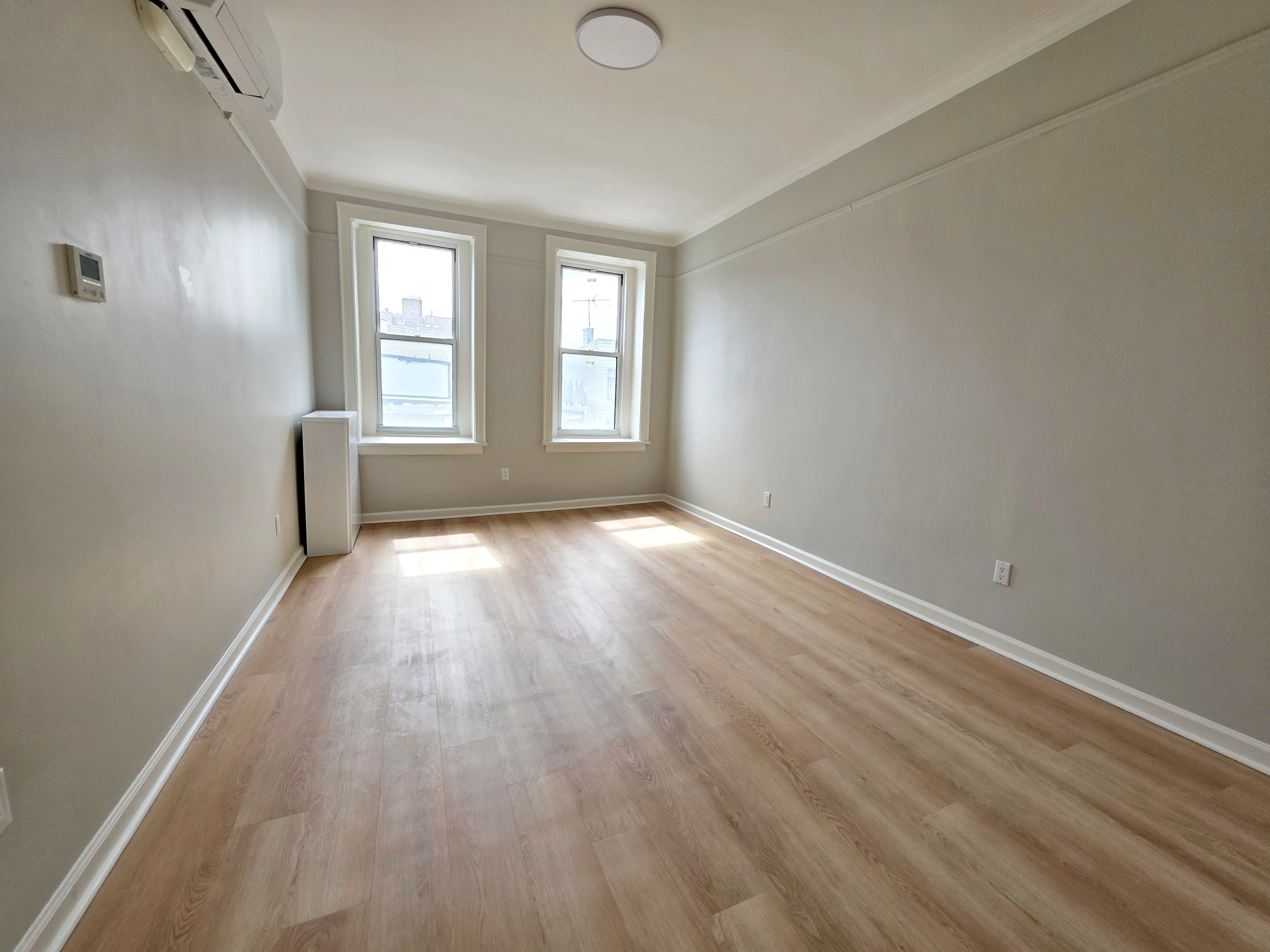 733 Metropolitan Avenue, Unit 3 Brooklyn, NY 11211 - Photo 10 of 13 an empty room with wooden floor and windows