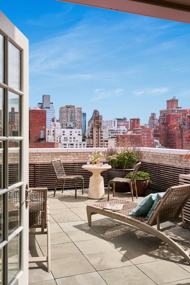 a terrace with a bench and chairs