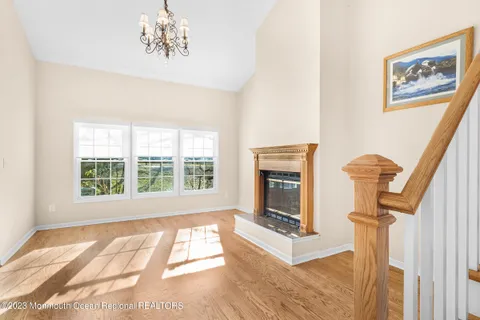 a view of an empty room with a fireplace and a window