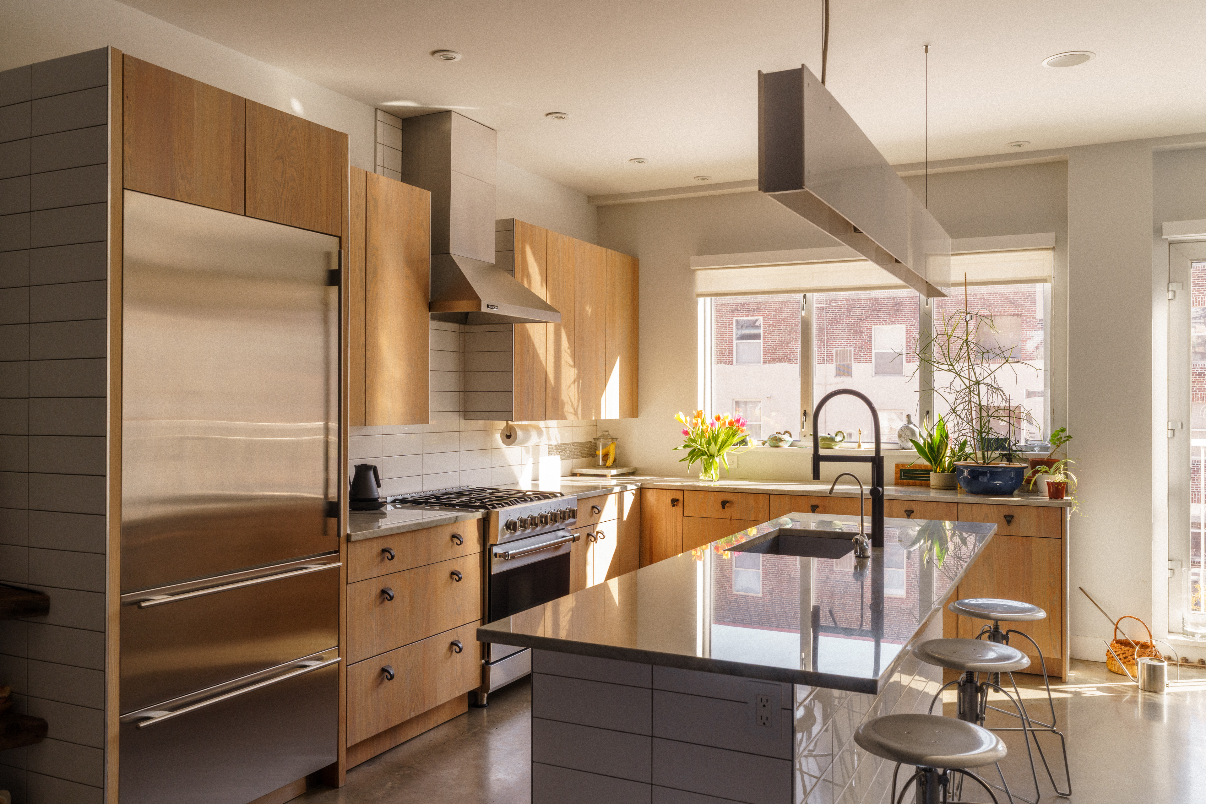 449 North 13th Street Philadelphia, PA 19123 - Photo 29 of 62 a kitchen with stainless steel appliances granite countertop a sink a stove and a refrigerator