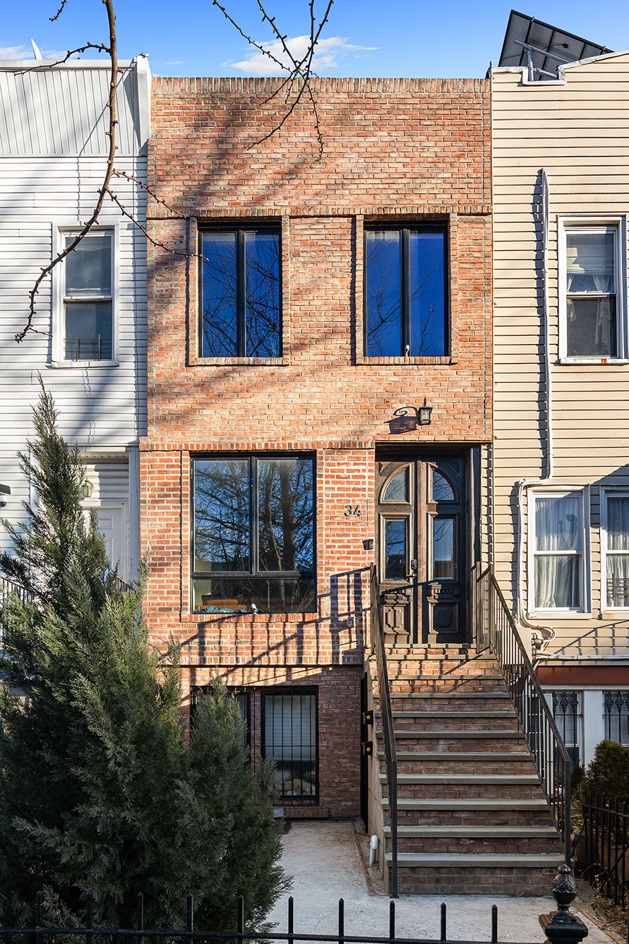 34 Woodbine Street Brooklyn, NY 11221 - Photo 14 of 15 a front view of a house with a garage