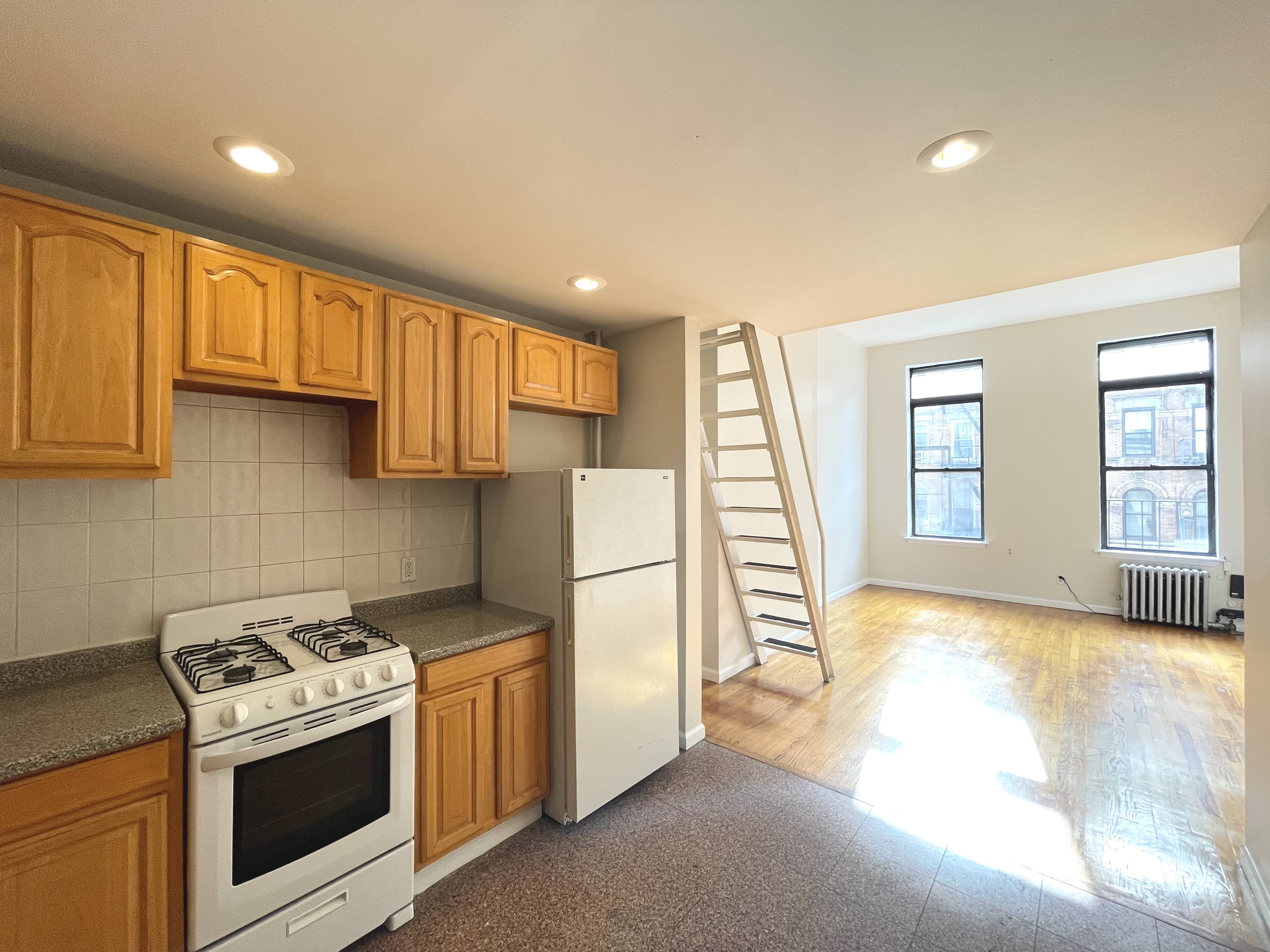 95 St Marks Place, Unit 6 Manhattan, NY 10009 - Photo 2 of 14 a kitchen with a stove a refrigerator and a sink