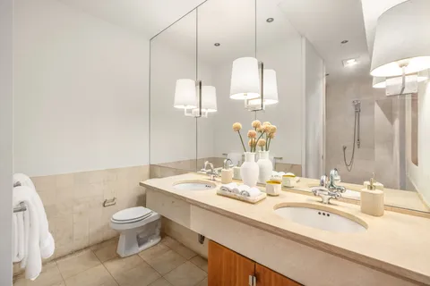 a bathroom with a double vanity sink and a mirror