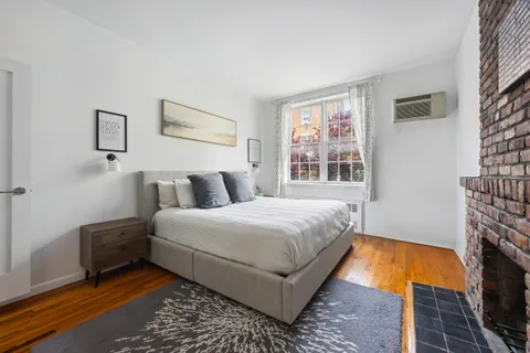 a bedroom with bed and a fireplace